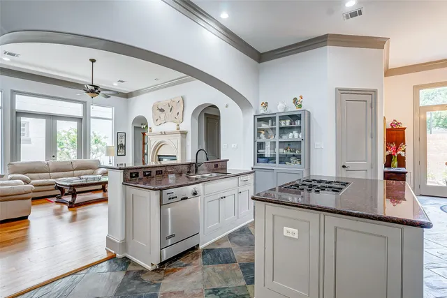 a kitchen with stainless steel appliances granite countertop a stove and cabinets