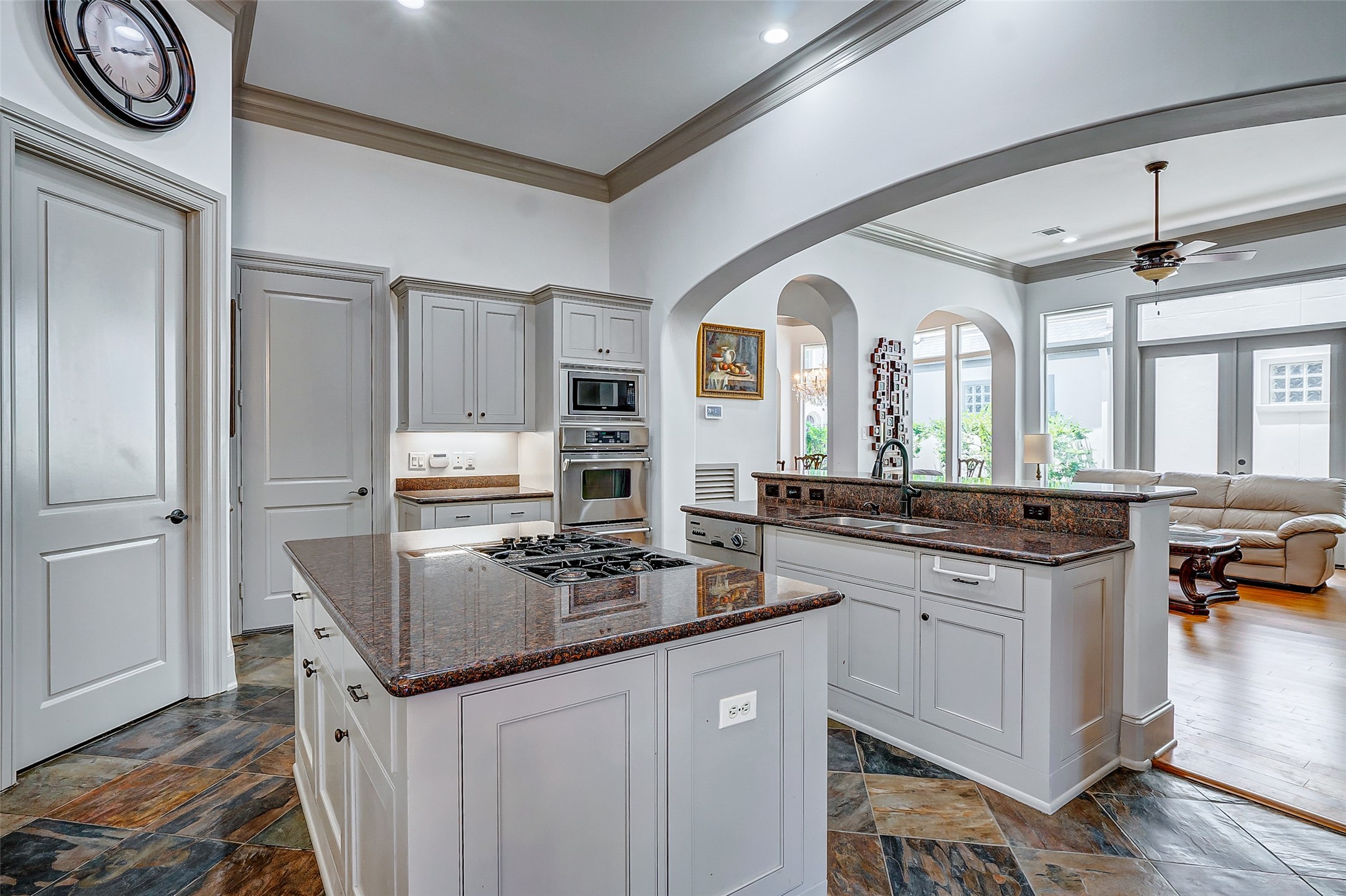2702 Tudor Manor Houston, TX 77082 - Photo 10 of 25 a kitchen with stainless steel appliances granite countertop a sink stove and cabinets