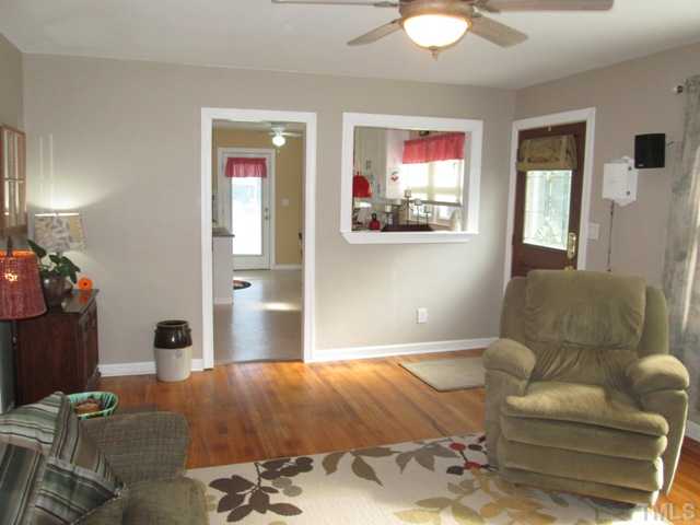 5507 Meadowbrook Road Raleigh, NC 27603 - Photo 14 of 25 The living room features lovely hardwood flooring, has a "passthru opening" to the kitchen, has a great picture window that allows for wonderful natural light to brighten your living space!