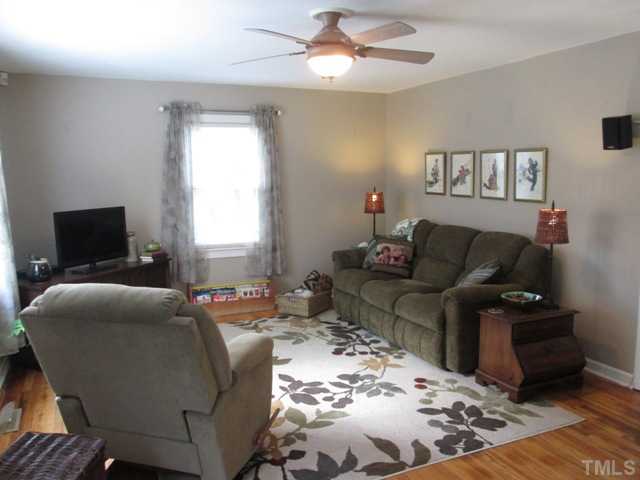 5507 Meadowbrook Road Raleigh, NC 27603 - Photo 15 of 25 Another view of your living room that has hardwood floors and features surround sound with speakers that will stay with the home!