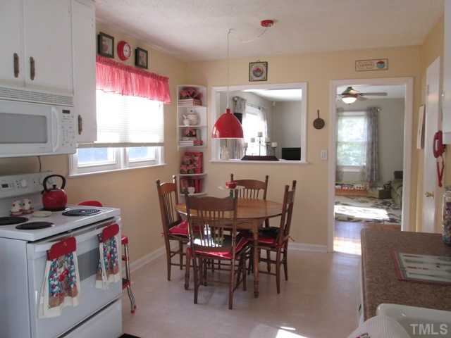5507 Meadowbrook Road Raleigh, NC 27603 - Photo 19 of 25 Your kitchen features updated counter tops, dishwasher, built-in microwave, a pantry that is great for added storage space, and the side door that leads out to the side yard with a fenced in area!