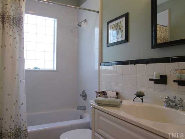 5507 Meadowbrook Road Raleigh, NC 27603 - Photo 22 of 25 Lovely bright bathroom features updated flooring, glass block window, updated vanity,, tile backsplash and partial tiled wall, medicine cabinet! Entire bathroom has been redone and updated!!