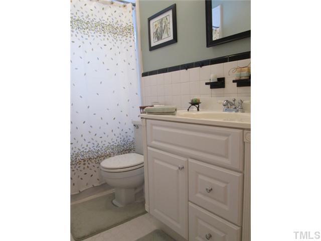 5507 Meadowbrook Road Raleigh, NC 27603 - Photo 23 of 25 Another view of your bathroom that has updated tile flooring, vanity, medicine cabinet! Bathroom also features a glass block window that is perfect for lots od added natural light!