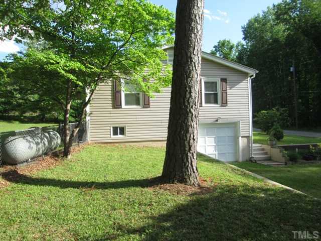5507 Meadowbrook Road Raleigh, NC 27603 - Photo 5 of 25 This is a view from the side yard, showing the one car garage. Wonderful mature trees surround the home and there is plenty of yard to have a garden, and lots of yard for the kids and pets to run and play!