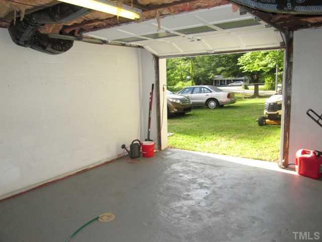 5507 Meadowbrook Road Raleigh, NC 27603 - Photo 8 of 25 Your one car garage and full basement features painted floors, Dry Lock on ail walls, and lots of room for all your gardening tools and mower!