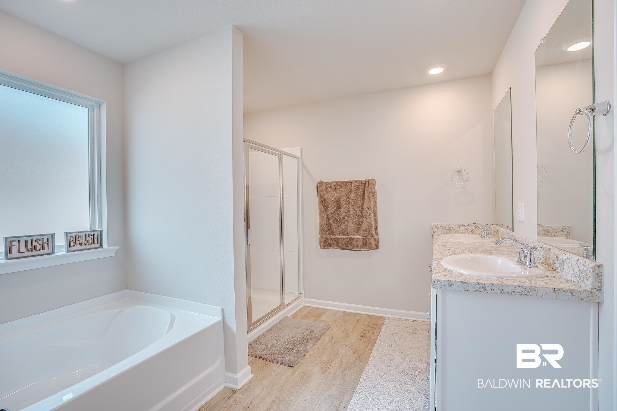 8242 Sycamore Way Semmes, AL 36575 - Photo 20 of 43 Bathroom with a garden tub, double vanity, a shower stall, wood finished floors, and recessed lighting