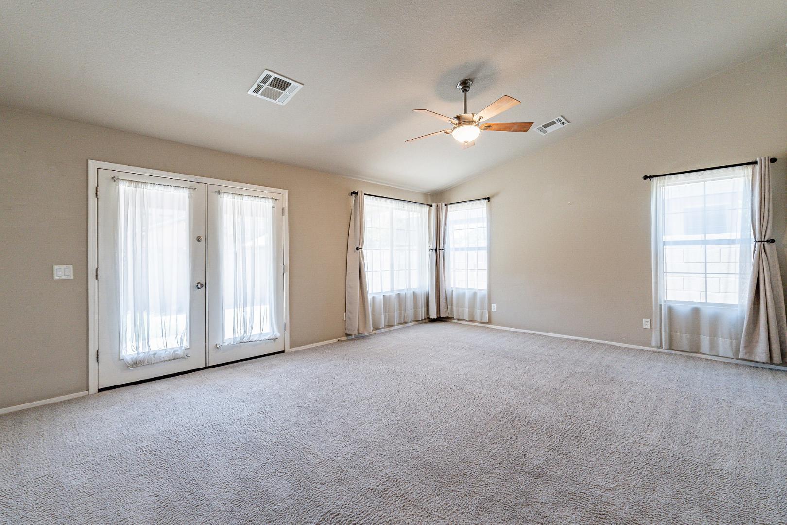 3713 East Utopia Road Phoenix, AZ 85050 - Photo 21 of 47 an empty room with windows and ceiling fan