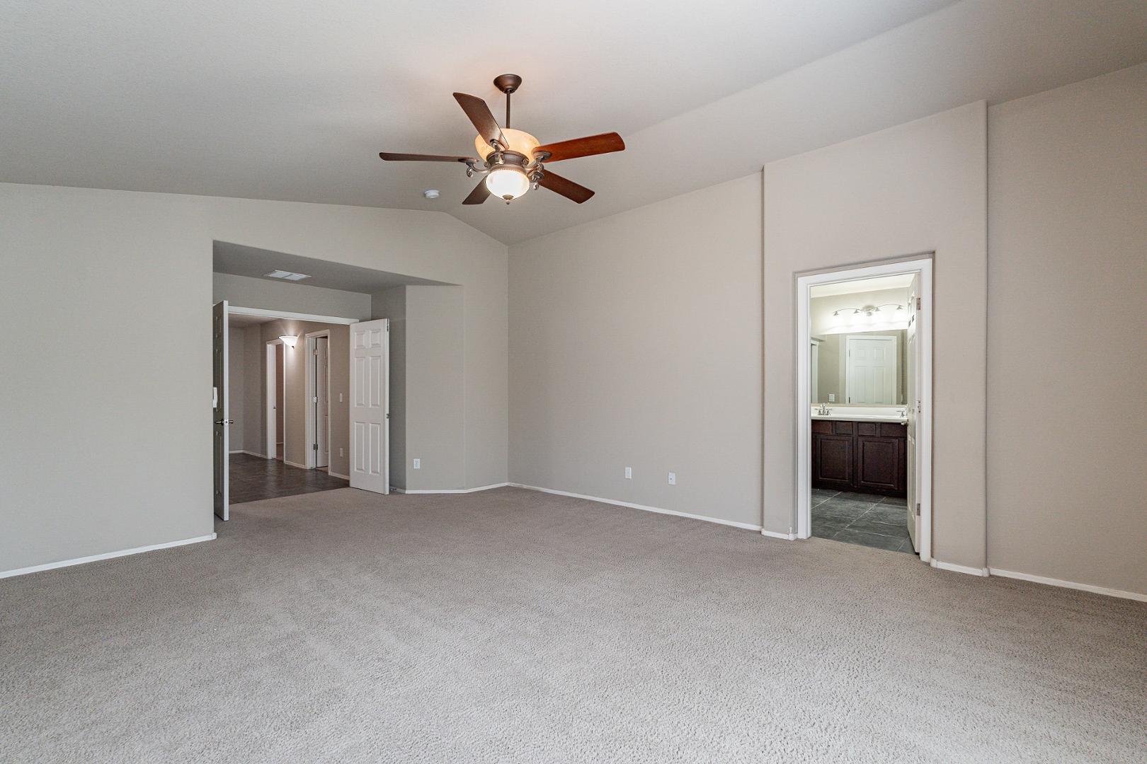 3713 East Utopia Road Phoenix, AZ 85050 - Photo 22 of 47 a view of an empty room with a chandelier fan