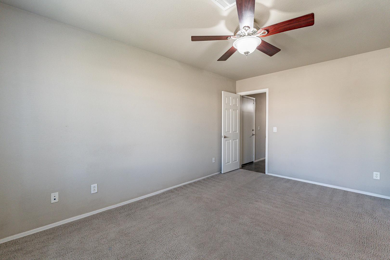 3713 East Utopia Road Phoenix, AZ 85050 - Photo 28 of 47 an empty room with a chandelier fan and windows