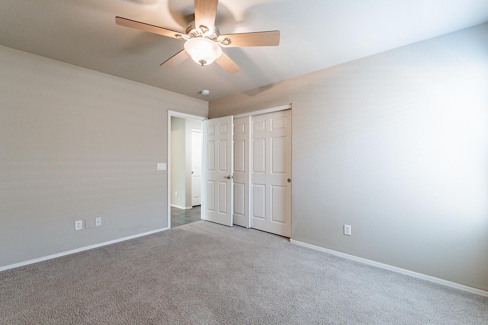 3713 East Utopia Road Phoenix, AZ 85050 - Photo 30 of 47 an empty room with a ceiling fan and a chandelier fan