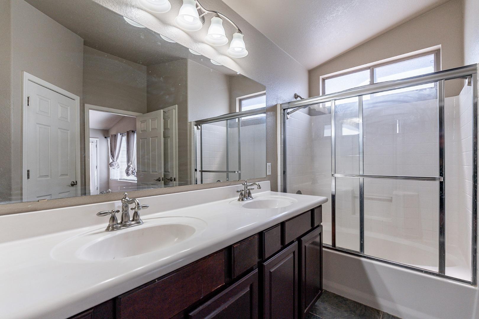 3713 East Utopia Road Phoenix, AZ 85050 - Photo 33 of 47 a bathroom with a double vanity sink a mirror and a shower