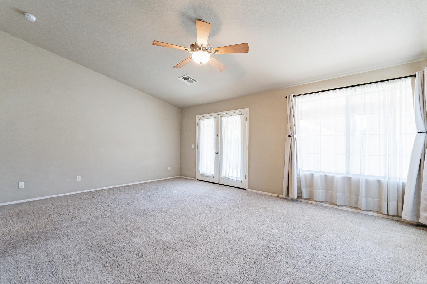 3713 East Utopia Road Phoenix, AZ 85050 - Photo 6 of 47 an empty room with fan and windows