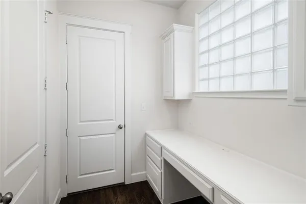 a utility room with cabinets washer and dryer