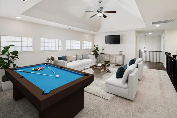 a living room with furniture pool table and a flat screen tv