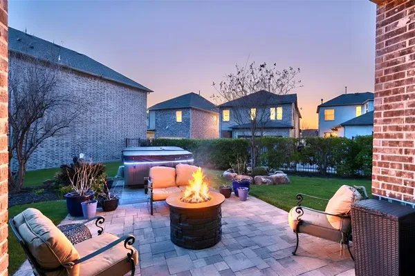 a view of a patio with couches table and chairs with garden and plants
