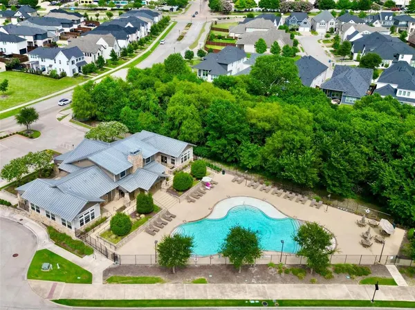 an aerial view of residential houses with outdoor space and street view