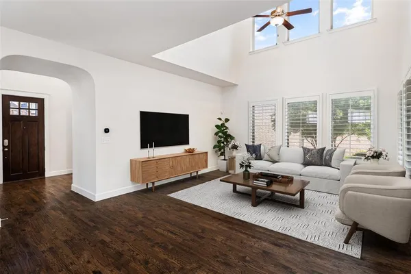 a living room with furniture wooden floor and a flat screen tv