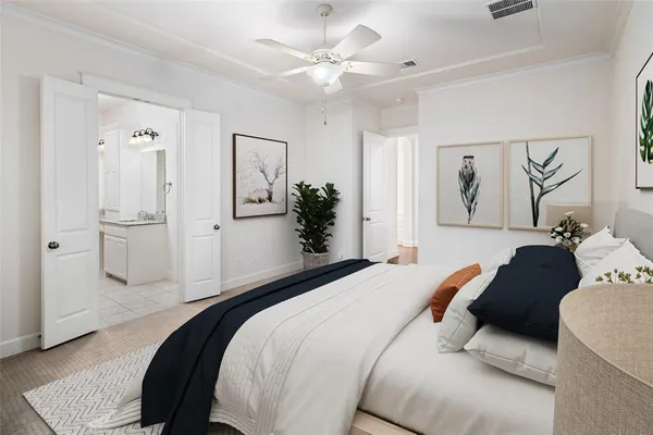 a spacious bedroom with a bed and a chandelier