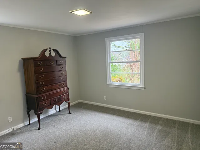a room with a dresser and a window