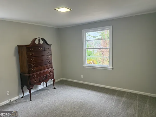a room with a dresser and a window