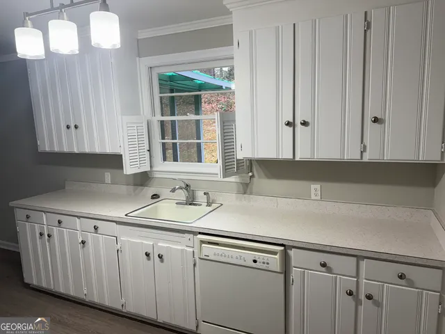 a view with cabinets a sink and dishwasher