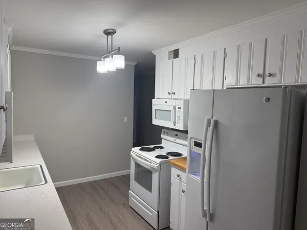 a kitchen with stainless steel appliances a refrigerator sink and cabinets
