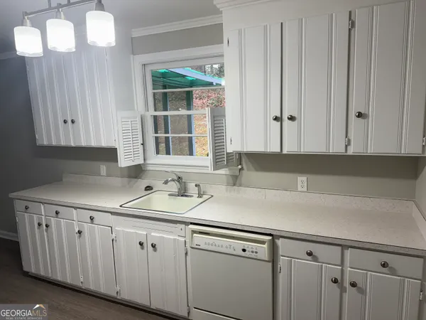 a view with cabinets a sink and dishwasher