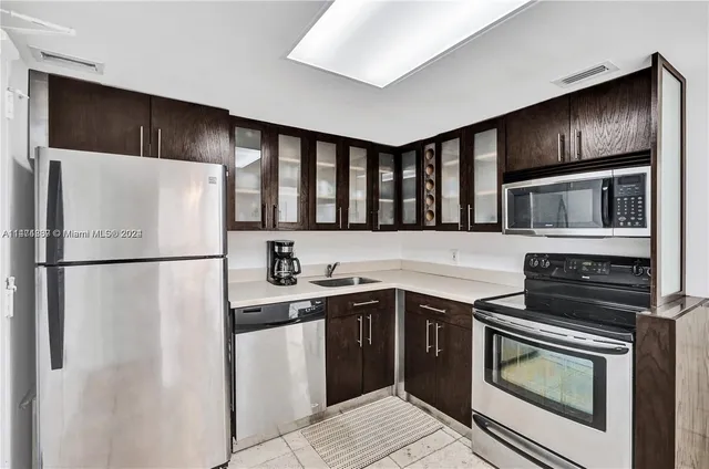 a kitchen with stainless steel appliances a refrigerator stove and microwave