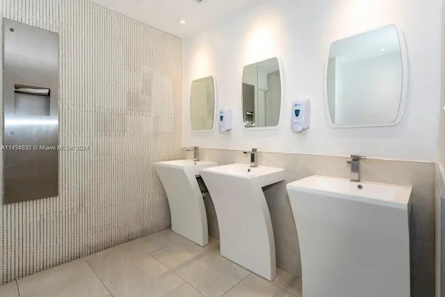 a view of a hallway with wooden floor and a potted plant