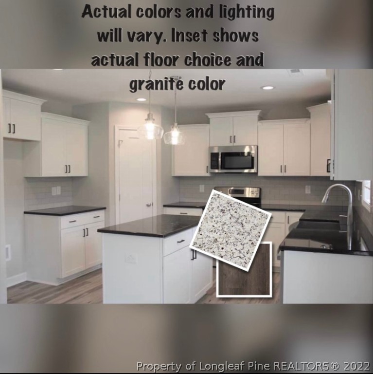 1319 Reservation Road Aberdeen, NC 28315 - Photo 6 of 6 a kitchen with kitchen island granite countertop a sink and a stove