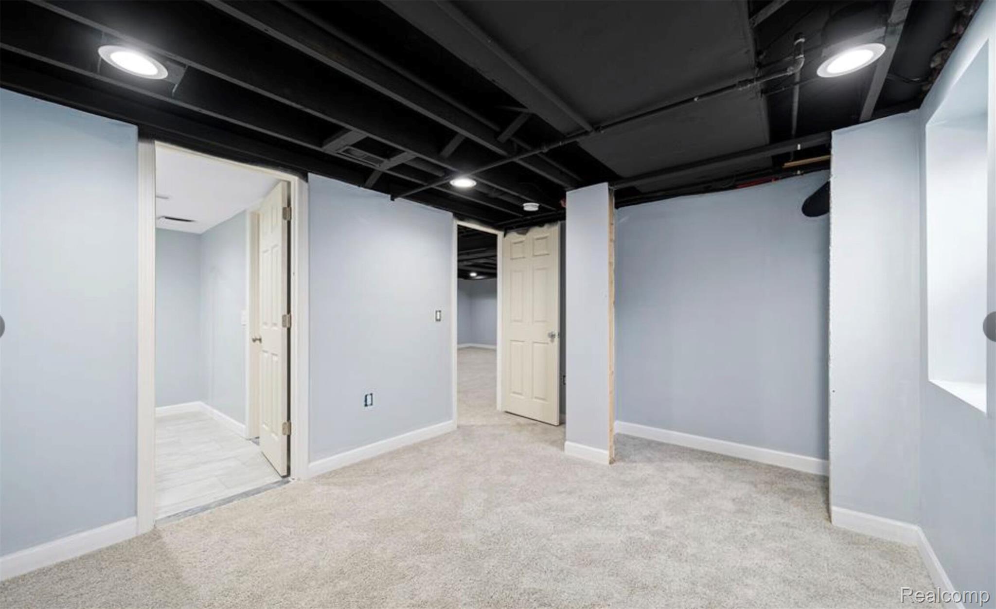 4214 Berkshire Road Royal Oak, MI 48073 - Photo 23 of 27 Carpeted lower level space featuring light gray walls and a painted black exposed ceiling