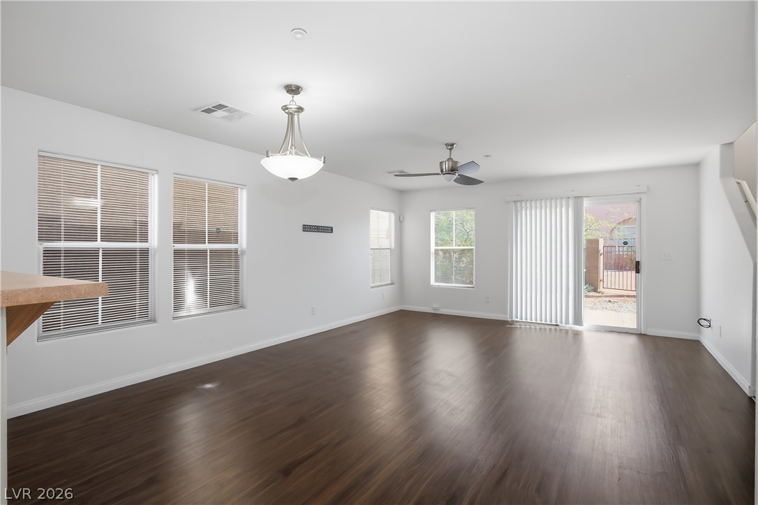 1172 Gecko Road Henderson, NV 89002 - Photo 3 of 30 A versatile open-concept living space features rich vinyl laminate flooring and abundant natural light.