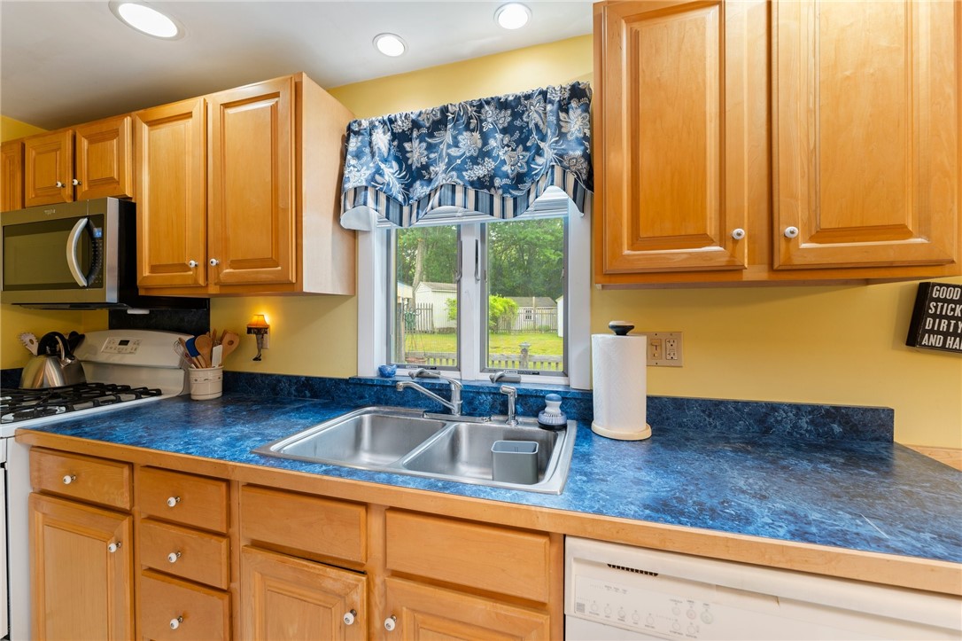 198 Lucas Road Warwick, RI 02818 - Photo 13 of 22 The kitchen is galley style with lots of cabinets