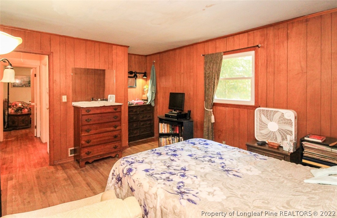 85 McIntyre Road Pinehurst, NC 28374 - Photo 12 of 20 a bedroom with a bed and a dresser