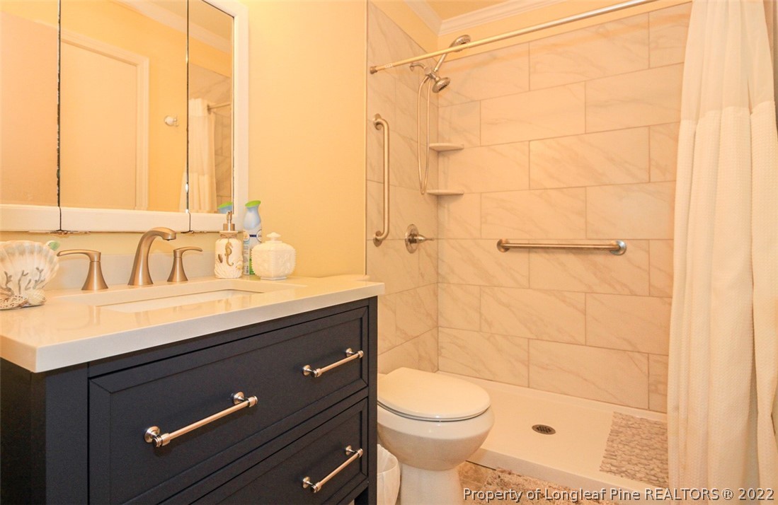 85 McIntyre Road Pinehurst, NC 28374 - Photo 14 of 20 a bathroom with a granite countertop sink toilet and shower