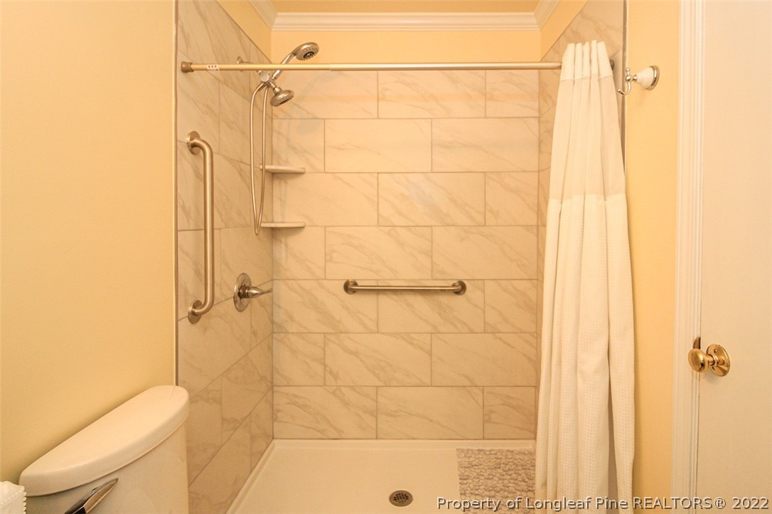 85 McIntyre Road Pinehurst, NC 28374 - Photo 15 of 20 a bathroom with a shower and a toilet