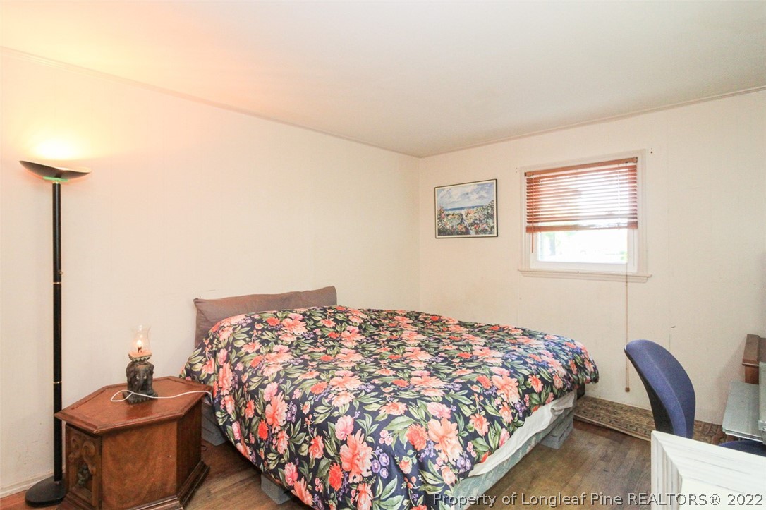 85 McIntyre Road Pinehurst, NC 28374 - Photo 16 of 20 a bedroom with a bed and chair