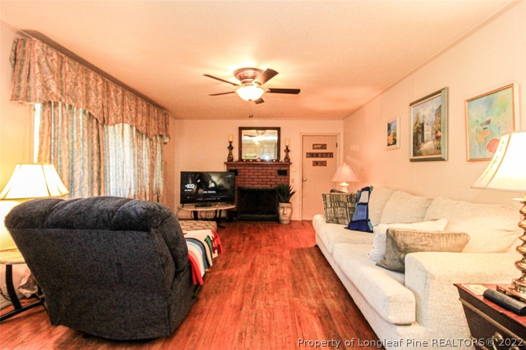 85 McIntyre Road Pinehurst, NC 28374 - Photo 5 of 20 a living room with furniture and a fireplace
