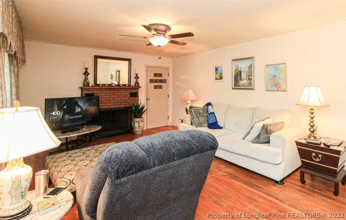 85 McIntyre Road Pinehurst, NC 28374 - Photo 6 of 20 a living room with furniture and a fireplace