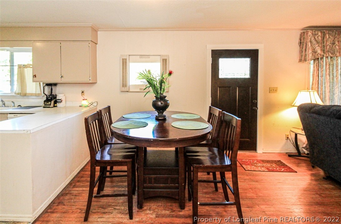 85 McIntyre Road Pinehurst, NC 28374 - Photo 7 of 20 a view of a dining room with furniture and wooden floor