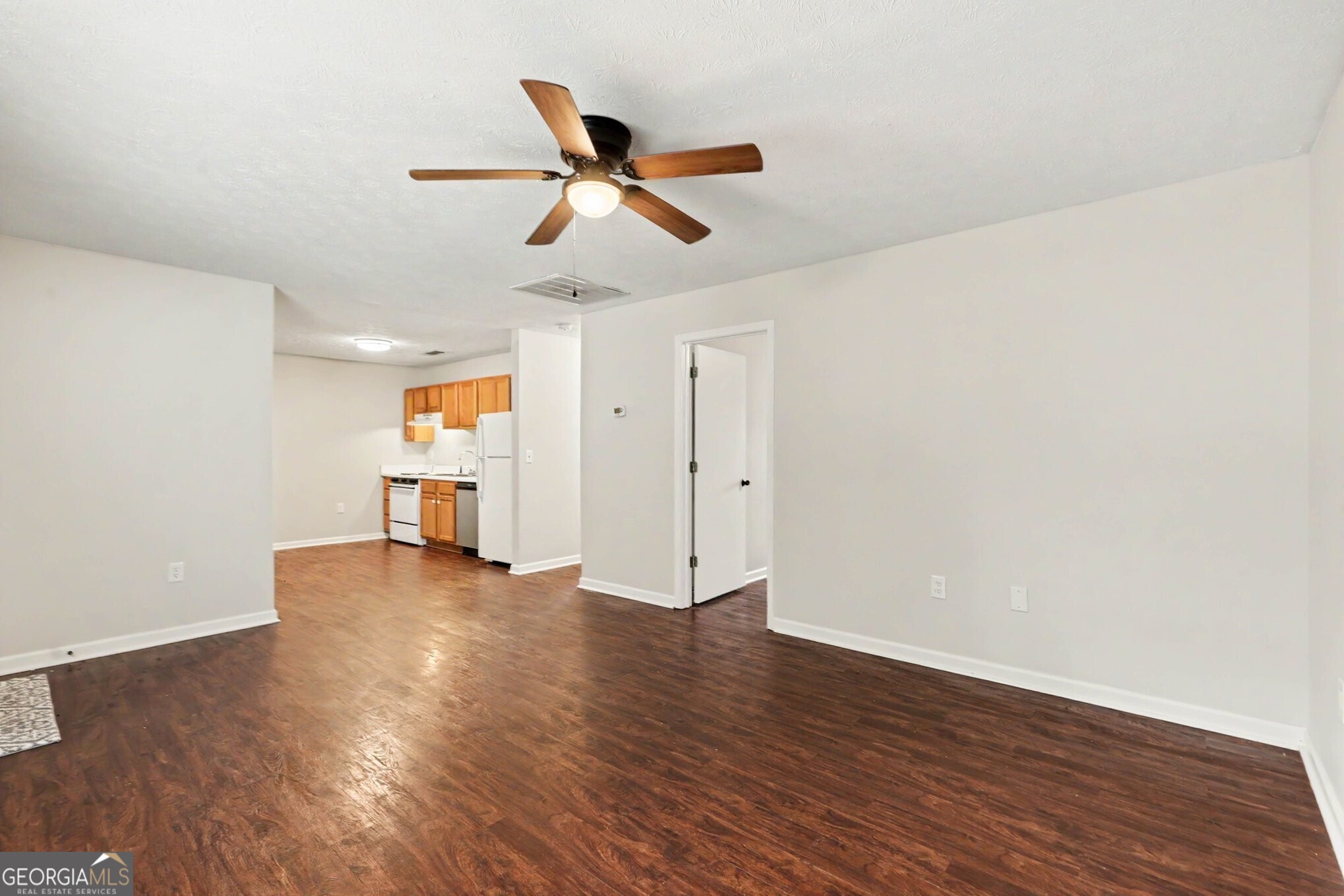 209 East Wilson Street Villa Rica, GA 30180 - Photo 6 of 24 SPACIOUS FAMILY ROOM THAT IS OPEN TO THE KITCHEN WITH LAMINATE FLOORING.