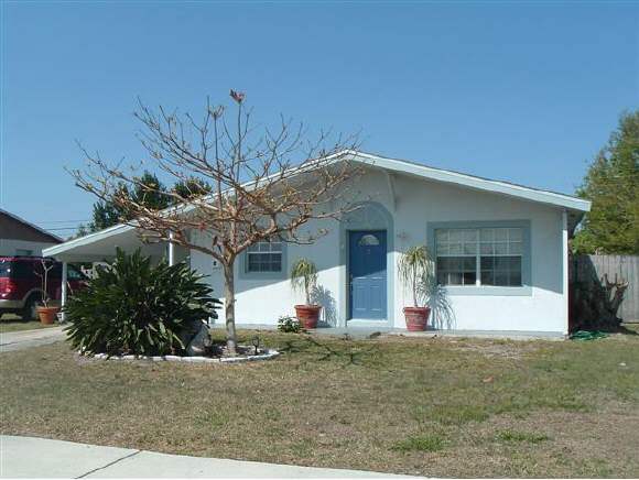 2568 Post Road Melbourne, FL 32935 - Photo 1 of 8 front view of a house with a yard