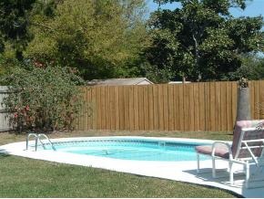 2568 Post Road Melbourne, FL 32935 - Photo 2 of 8 a view of a backyard with a chair and potted plants