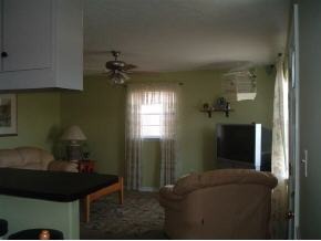 2568 Post Road Melbourne, FL 32935 - Photo 3 of 8 a living room with furniture and a chandelier