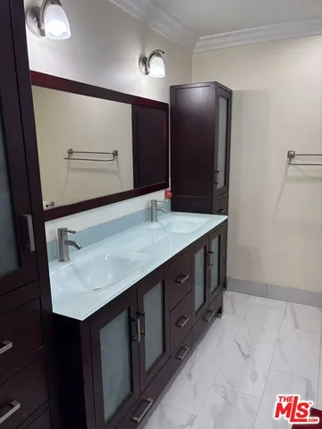 a bathroom with a sink vanity and a mirror