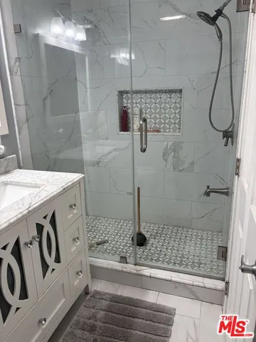 a bathroom with a sink and shower