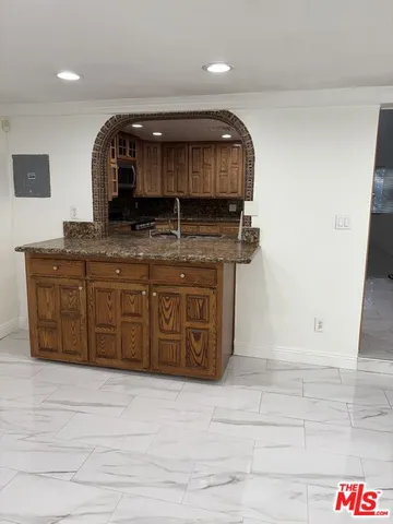 a bathroom with a granite countertop double vanity sink and a mirror