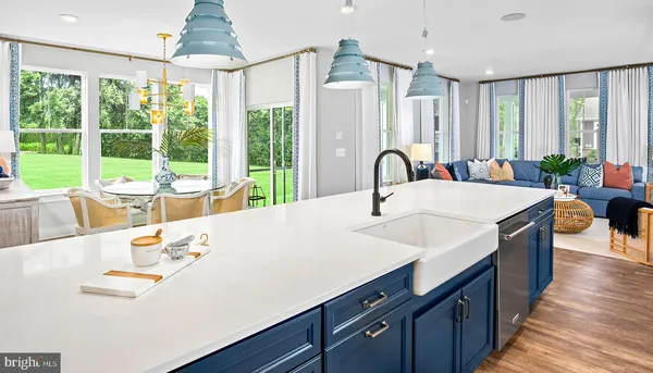a large kitchen with stainless steel appliances a large window in it