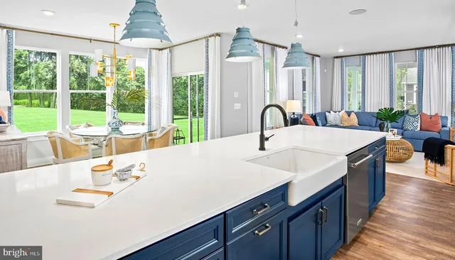 a large kitchen with stainless steel appliances a large window in it