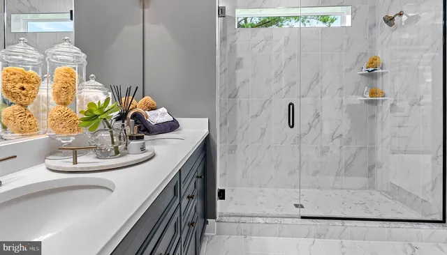 a bathroom with a sink a mirror and shower